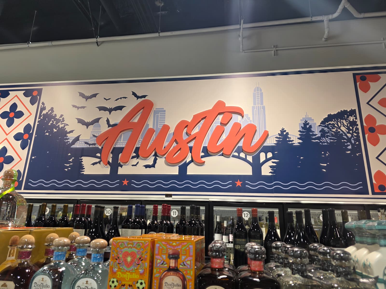 Austin skyline and bats mural above the wine coolers